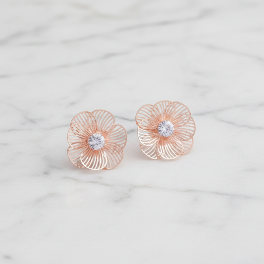 Rose Gold Flower Stud Earrings on white marble surface