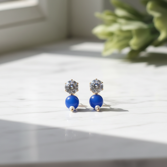 Blue Crystal Drop Earrings on white marble surface