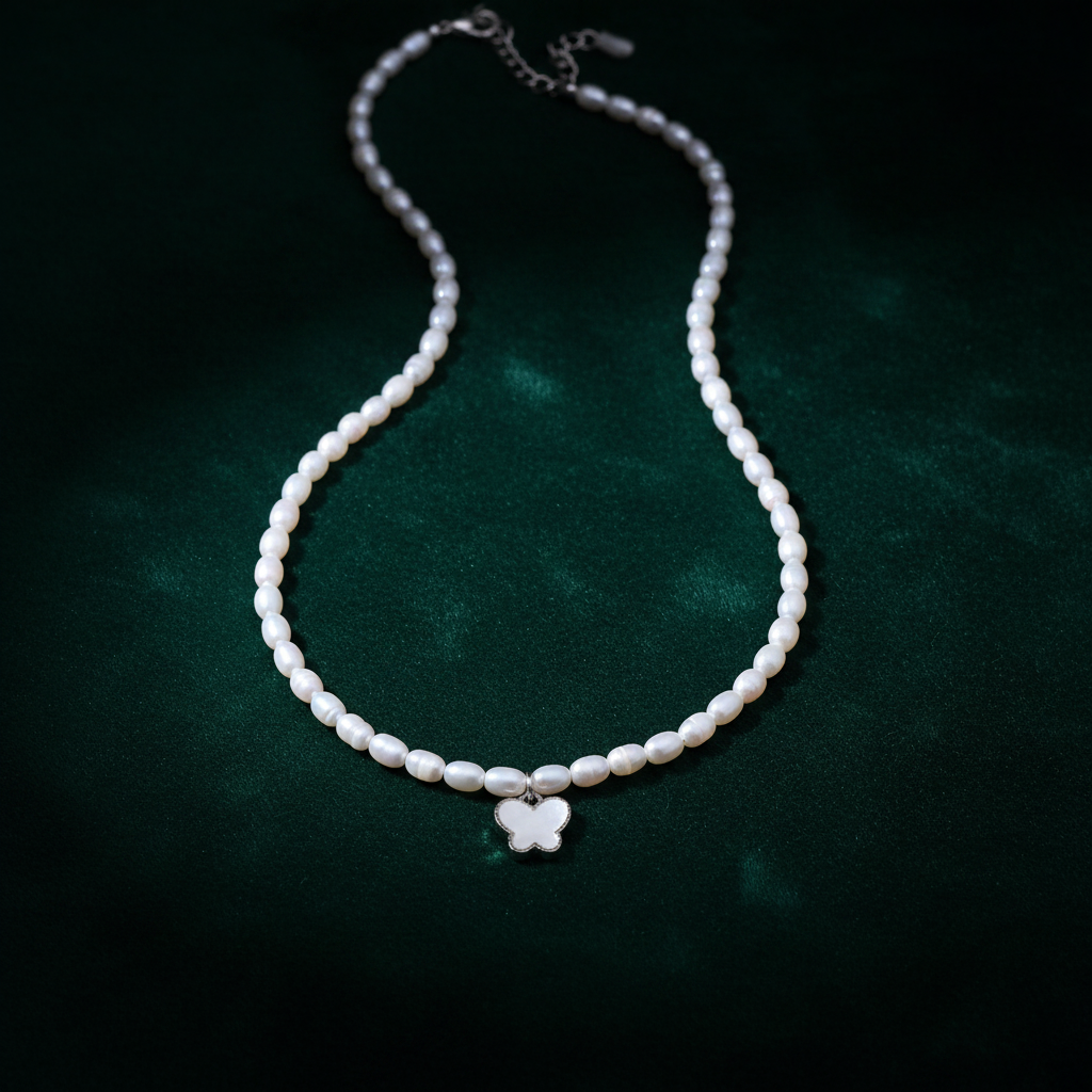 Pearl Butterfly Necklace on dark green velvet moody editorial