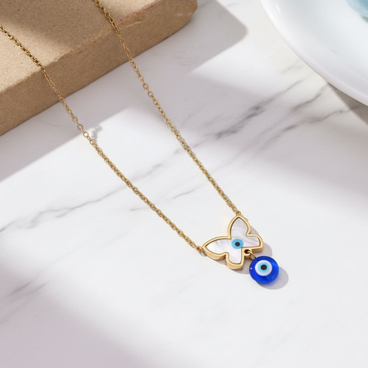 Butterfly Evil Eye Necklace on white marble surface